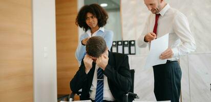 Team thinking of problem solution at office meeting, sad diverse business people group shocked by bad news, upset colleagues in panic after company bankruptcy concept photo