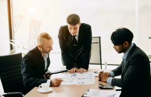 Business team discuss at meeting room. working together with laptop ,tablet and smart phone on desk Financial accountant , planner , meeting , introduction concept. At office photo