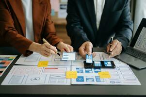 UX graphic designer planning application process development prototype wireframe for web smart phone. Creative digital development agency. photo