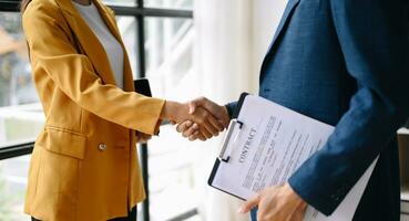 Two confident business man shaking hands during a meeting in the office, success, dealing, greeting and partner photo