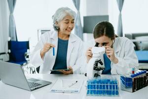 Scientist team meeting and writing analysis results in the laboratory study and analyze scientific sample, test samples photo