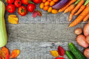 Assortment different fresh organic vegetables on country style wooden background. Healthy food vegan vegetarian dieting concept. Local garden produce clean food. Frame top view flat lay copy space. photo