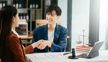 Consultation between a male lawyer and business customer, handshake after good deal agreement, Law and Legal concept.Good service cooperation photo