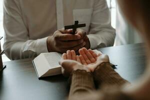 Two people reading and study bible in home and pray together.Studying the Word Of God photo