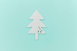 Simply minimal composition winter objects ornament fir tree isolated on blue pastel trendy background photo