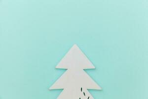 Simply minimal composition winter objects ornament fir tree isolated on blue pastel trendy background photo