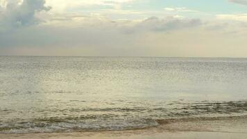 Jet airplane approaching before landing at Phuket International airport, beautiful waves on beach, slow motion. video