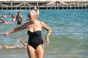 Low Angle View of People Who are Enjoying Summer's Hot Day at Bournemouth Beach of England, Great Britain. UK. August 23rd, 2023 photo