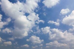 Beautiful light blue sky with cloud for background. the Cumulus cloud with the sun in midday. photo