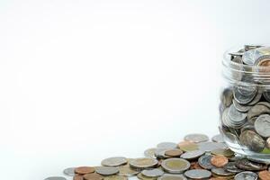 Thai Coins in grass jar isolated on white background. This image for background. photo