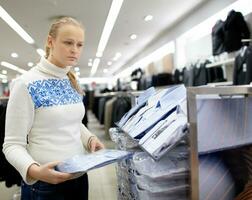 Woman is choosing shirt for man. photo