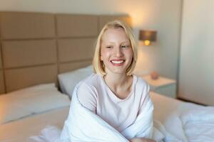 Woman wrapped in a blanket after wake up, entering a day happy and relaxed after good night sleep. Sweet dreams, good morning, new day, weekend, holidays concept photo