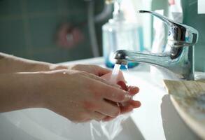 Washing of hands with soap photo