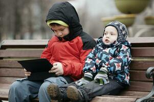 Brothers with tablet computer photo