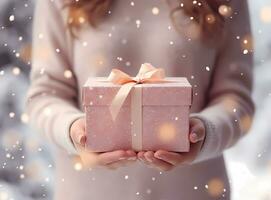 Woman holding gift box in hands. Christmas celebration.  With boke. photo