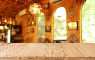 Empty wooden table in front of abstract blurred background of coffee shop . can be used for display or montage your products.Mock up for display of product photo