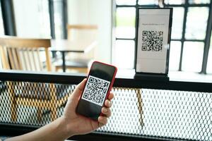 Qr code payment. E wallet. Man scanning tag accepted generate digital pay without money.scanning QR code online shopping cashless payment and verification technology concept photo