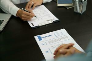 Examiner reading a resume during job interview at office Business and human resources concept. photo