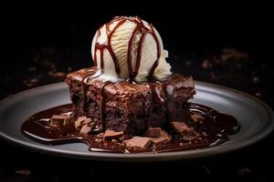 Brownie with ice cream on top, dark background. photo