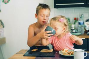 Siblings having breakfast together photo