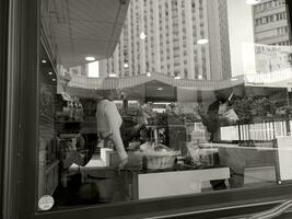 Cafe window with city reflection in black and white, Paris photo