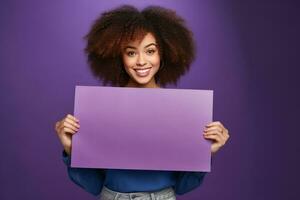 Cheerful african american woman holding a rectangular template for text in her hands on a purple plain background. Mocap, banner, copy space. AI Generated photo