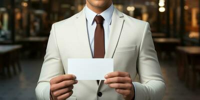 Businessman hand showing blank white business card in closeup photo