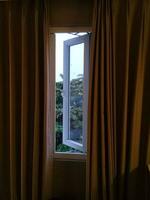 View of trees from windows and curtains photo