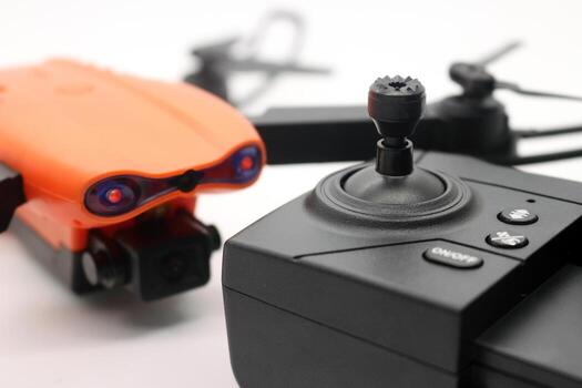 Orange drone with camera and remote control photo