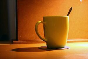 Empty cup and spoon with elegant light photo