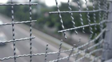 Broken iron wire fence over highway photo