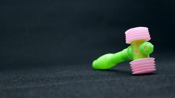 Green little hammer toy for kids photo