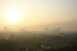 The view of the sunrise in the middle of the city seen from above photo