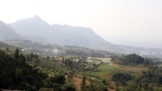 View of a mountain covered in mist and clear clouds photo