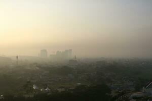 The view of the sunrise in the middle of the city seen from above photo