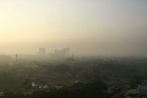 The view of the sunrise in the middle of the city seen from above photo