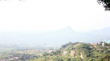 View of a mountain covered in mist and clear clouds photo