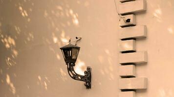 Old black wall hanging lamp in an old house photo