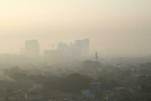 The view of the sunrise in the middle of the city seen from above photo