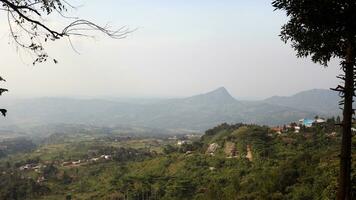 View of a mountain covered in mist and clear clouds photo