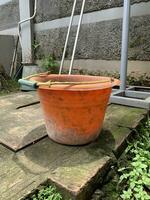 Closeup of old and dirty little red bucket, in a home garden. photo