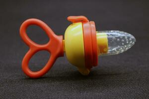 Orange baby pacifier with lid photo