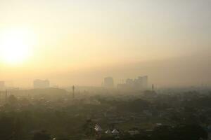 The view of the sunrise in the middle of the city seen from above, photo