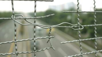 Broken iron wire fence over highway photo