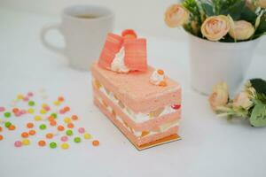 Slice of cake on white marble background. Selective focus. photo