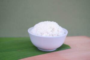 Cooked rice in a bowl on a banana leaf. Selective focus. photo