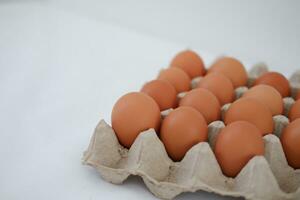 Eggs in a carton box on a white background. photo