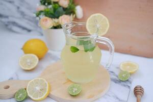 Lemonade with fresh lemon and mint leaves on a white background photo