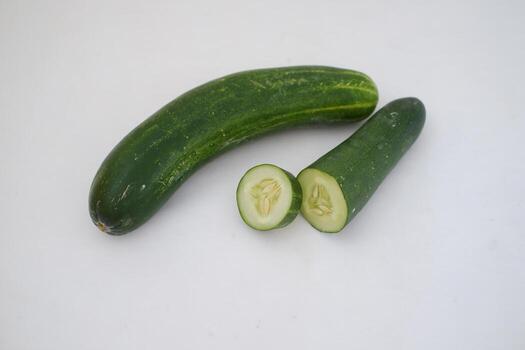 Cucumber and slices on a white background. Selective focus. photo