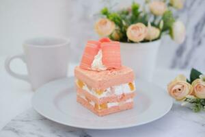 Slice of cake on white marble background. Selective focus. photo